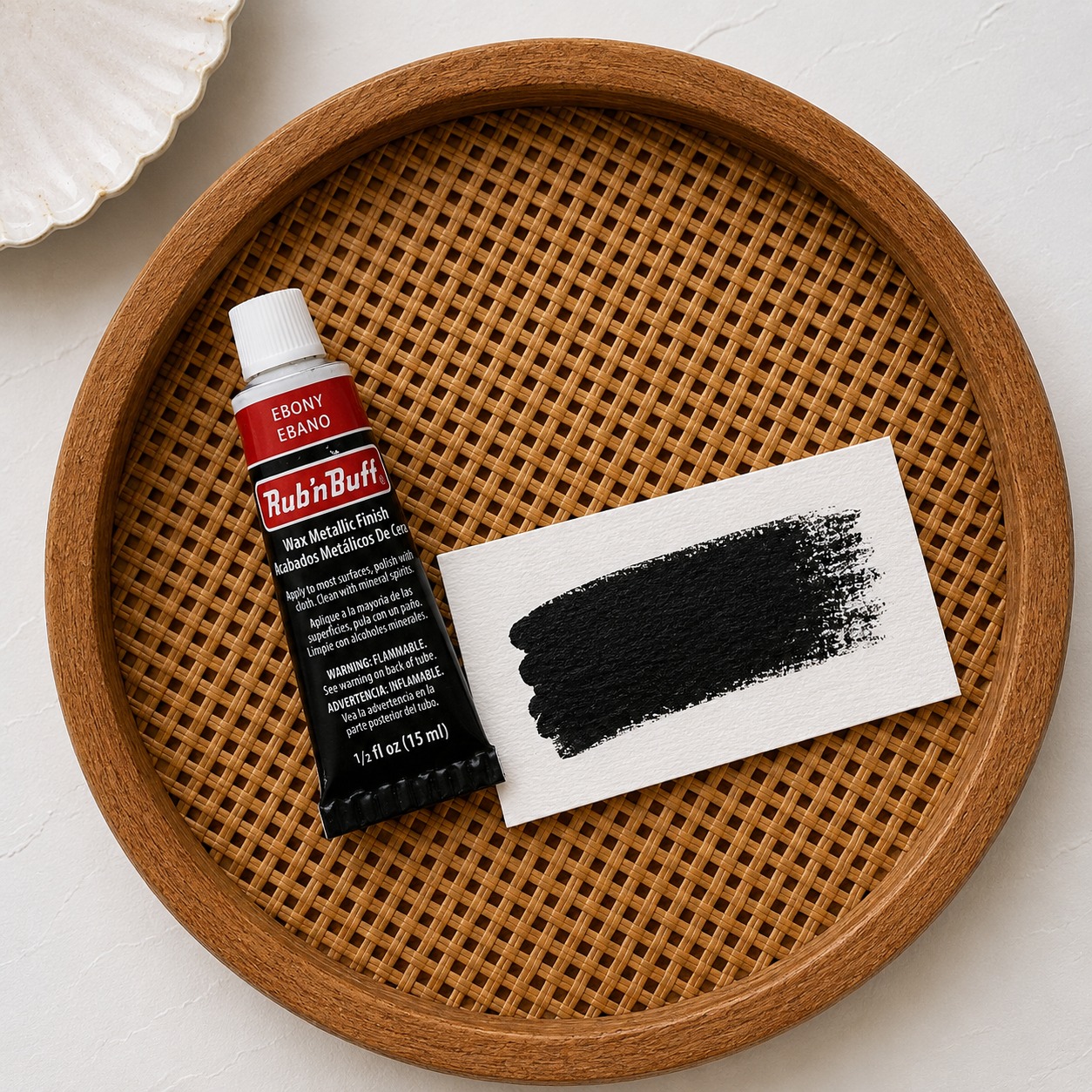 Rub 'n Buff Ebony Enameled Powder on a wooden tray with a white background